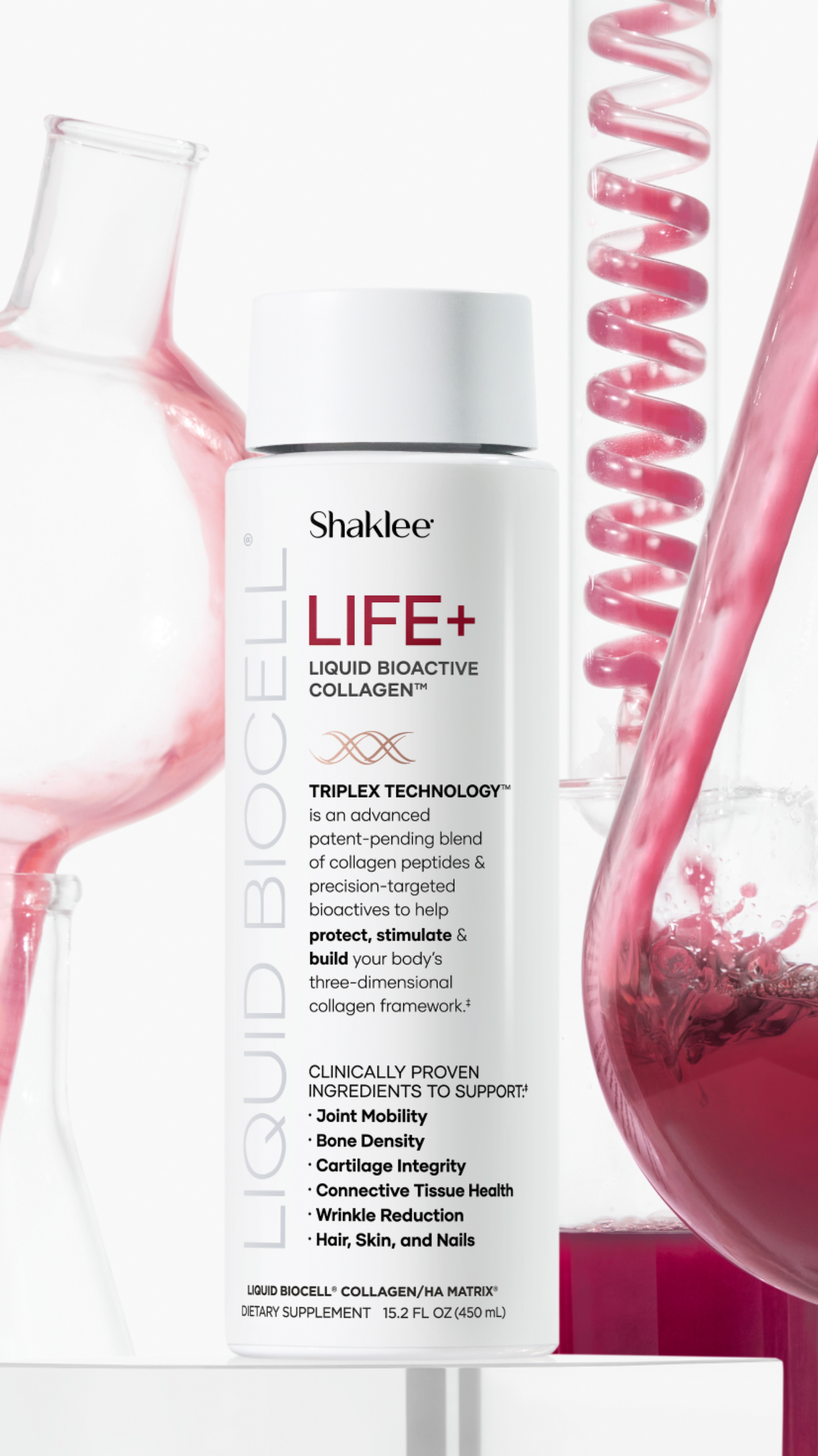 Life Plus Glass with Beaker on White Story - Shop Shaklee Australia Bottle of Shaklee LIFE+ Liquid Bioactive Collagen dietary supplement with pink lab glassware in background on white surface.