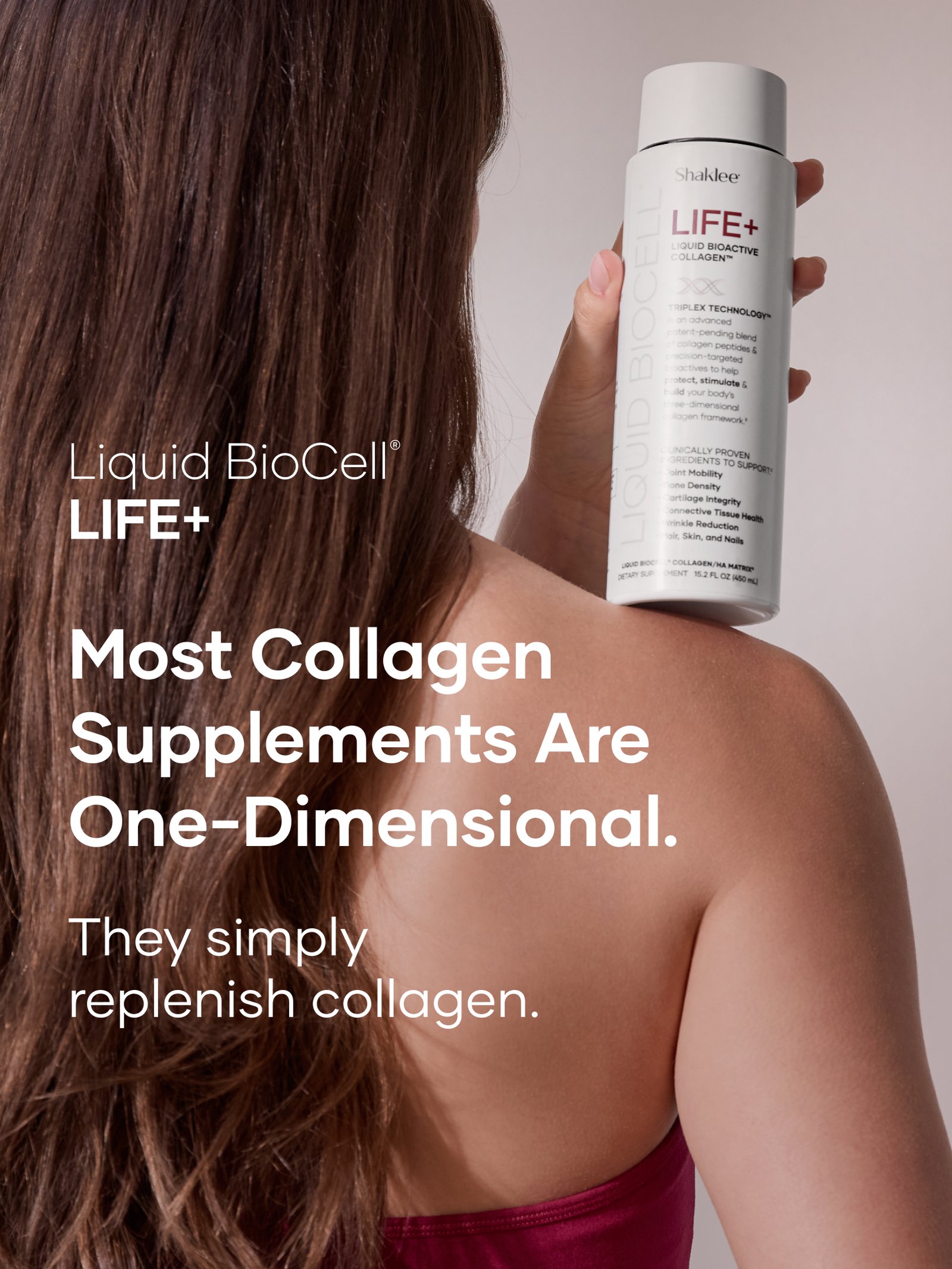Life+ What Makes Life Plus Different Carousel Slide 1 US English - Shop Shaklee Australia Back of a woman's head with long brown hair as she holds a white bottle labeled Shaklee LIFE+ Liquid BioActive Collagen in view.